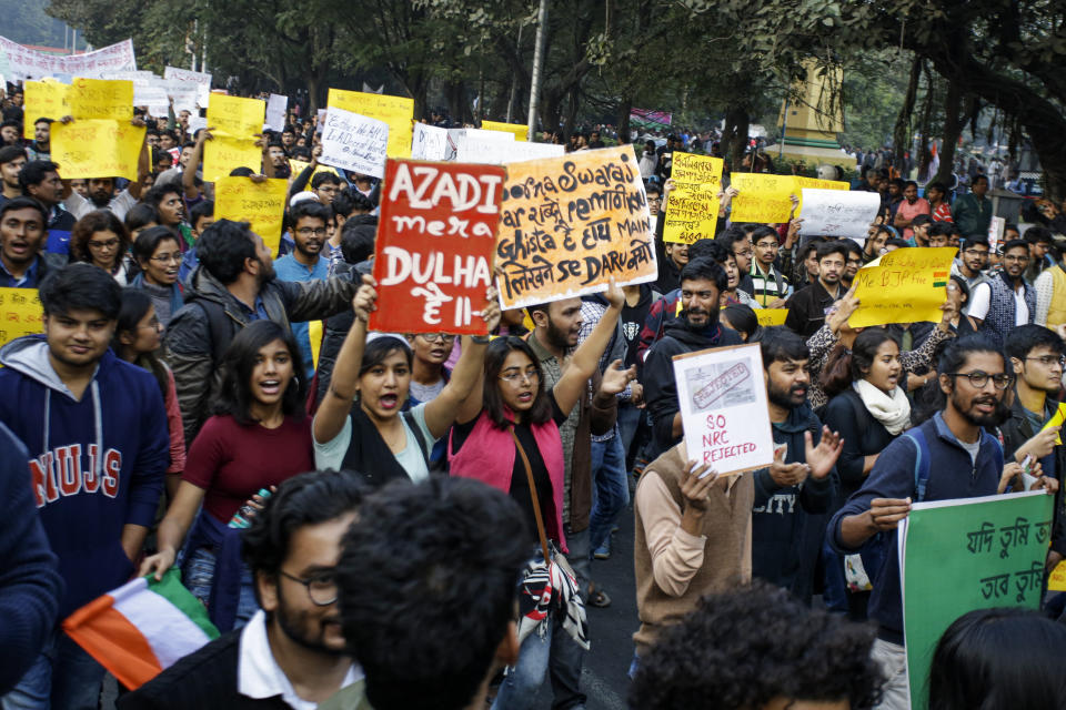 Activists of the Communist Party of India (Marxist-Leninist) and alliance march in a protest rally against the Citizenship Amendment Act, in Kolkata, India, Saturday, Dec. 21, 2019. Critics have slammed the law as a violation of India's secular constitution and have called it the latest effort by the Narendra Modi government to marginalize the country's 200 million Muslims. Modi has defended the law as a humanitarian gesture. Banner reads, withdraw CAA and NRC bills, join the rally and meeting. (AP Photo/Bikas Das)