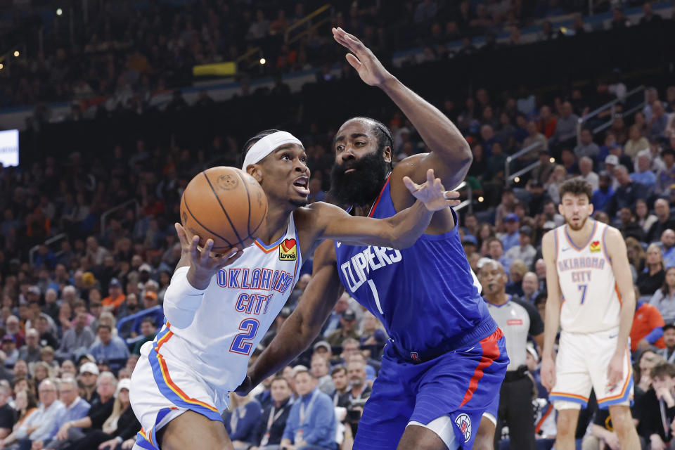 Feb 22, 2024; Oklahoma City, Oklahoma, USA; Oklahoma City Thunder guard Shai Gilgeous-Alexander (2) moves to the basket beside LA Clippers guard James Harden (1) during the second quarter at Paycom Center. Mandatory Credit: Alonzo Adams-USA TODAY Sports