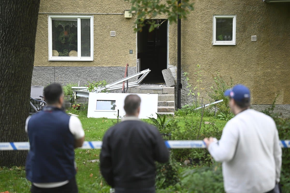 People look at the damage the day after an explosion hit an apartment building in Hässelby, Sweden (FREDRIK SANDBERG)