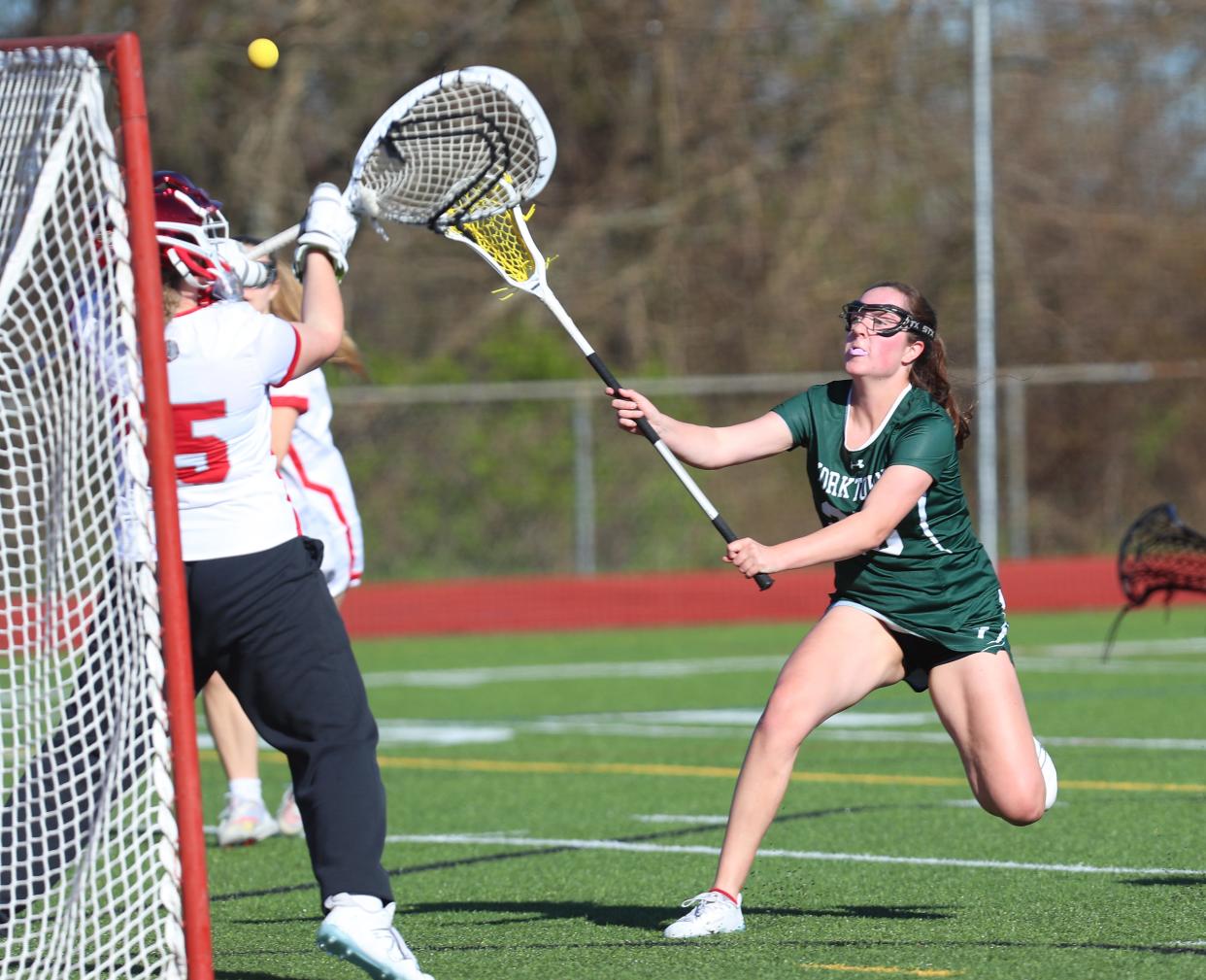 Yorktown's Ava Cunneen (25) fires a shot on goal against Somers during girls lacrosse action at Somers High School April 25, 2024. Yorktown won the game 8-5.