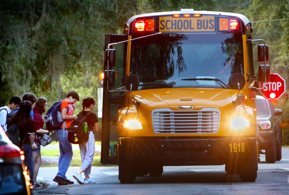 Alachua County School students board a school bus off NW 24th Blvd. in Gainesville, Fla. on the morning of October 8, 2019.