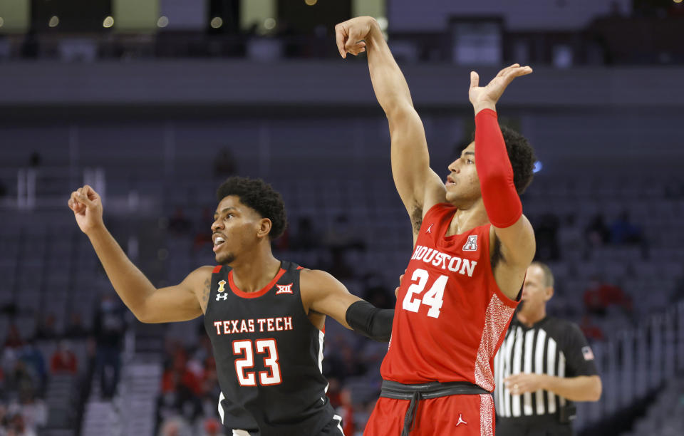Houston guard Quentin Grimes (24) watches his three-point shot-attempt as Texas Tech guard Chibuzo Agbo (23) looks on during the second half of an NCAA college basketball game, Sunday, Nov. 29, 2020, in Fort Worth, Texas. (AP Photo/Ron Jenkins)