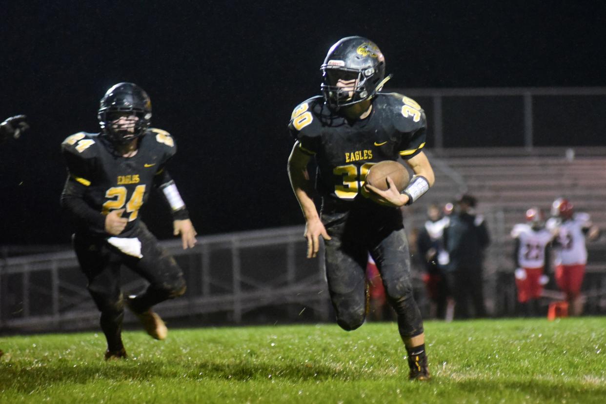 Tanner Dyer carries the ball during Saturday's 50-0 win.