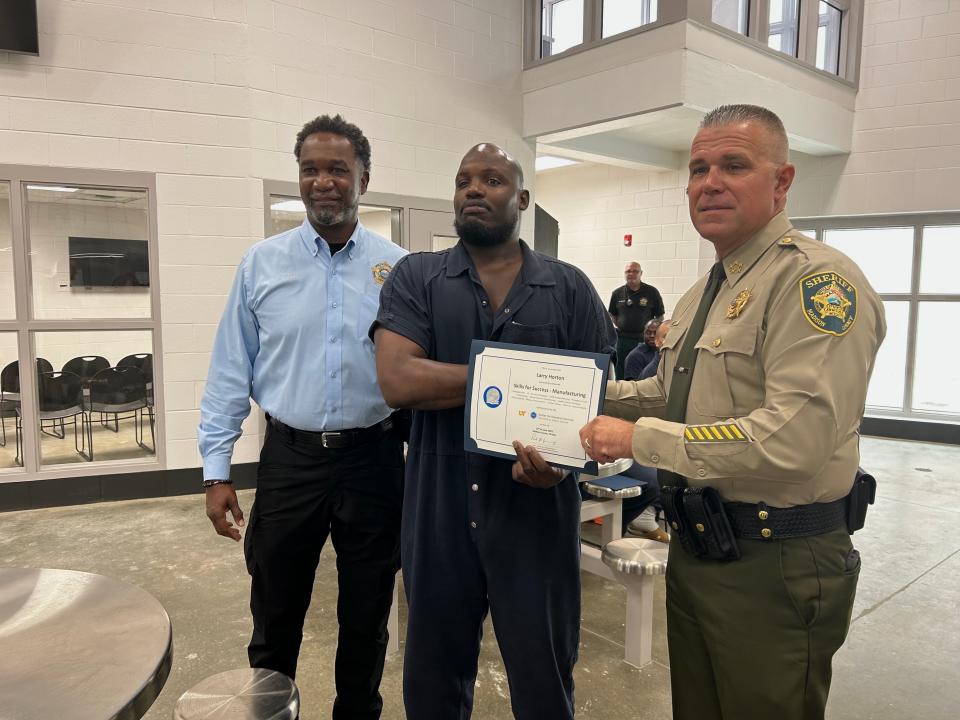 Larry Horton (middle) poses for a picture with Madison Co. Jail Operations Chief Eddie Dowdy (left) and Madison Co. Sheriff Julian Wiser after receiving his certificate in manufacturing on June 15, 2023.