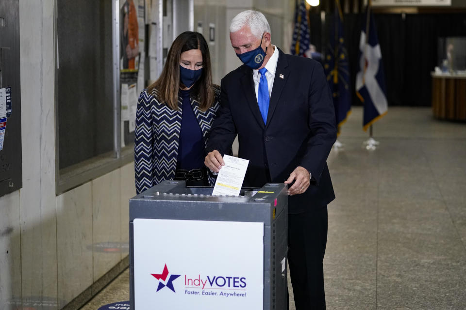 Vice President Mike Pence and his wife Karen, cast their ballots during early voting in Indianapolis, Friday, Oct. 23, 2020. (AP Photo/Michael Conroy)