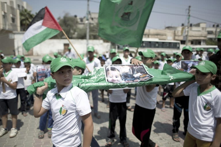 Palestinian children carry a funeral stretcher with a picture of 18-month-old Ali Saad Dawabsha, the toddler who was burned to death by suspected Jewish extremists, during a protest in Khan Yunis in the southern Gaza Strip on August 1, 2015