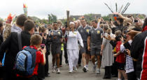 Silvia Sanchez Alcantara carries the Olympic Flame on the Torch Relay leg between Stoke Mandeville and Aylesbury.