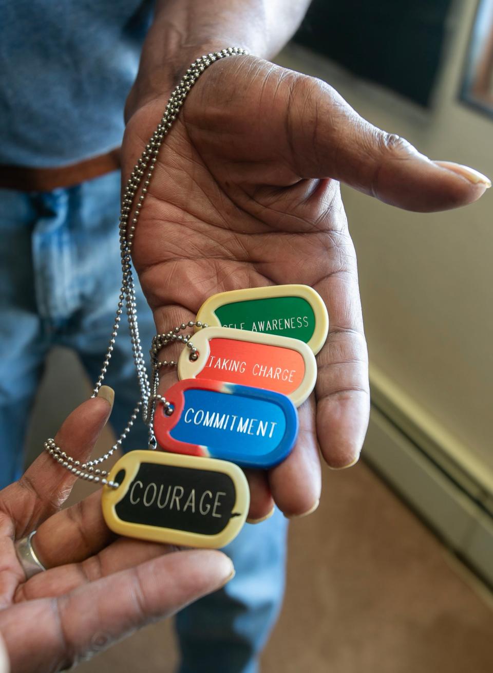 Teddy Henderson, of Sheboygan, shows, Tuesday, March 14, 2023, some of the special dog tags that have helped him since he went through the veterans court in Sheboygan, Wis.