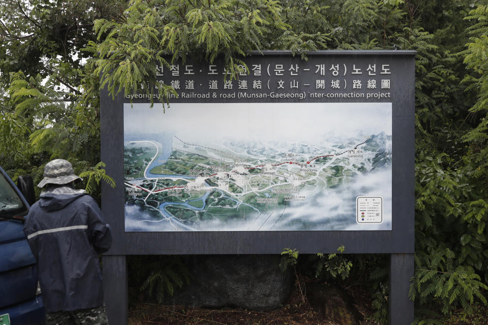 A man walks in front of a map of railroad and road between two Koreas cities, South's Munsan and North's Kaesong, at the Imjingak Pavilion in Paju, South Korea, Wednesday, June 24, 2020. North Korea said Wednesday leader Kim Jong Un suspended a planned military retaliation against South Korea, possibly slowing the pressure campaign it has waged against its rival amid stalled nuclear negotiations with the Trump administration. (AP Photo/Lee Jin-man)