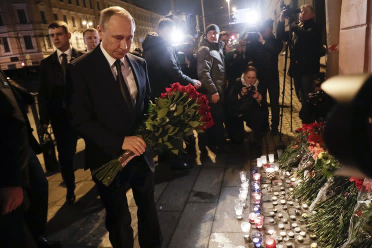 Vladimir Putin leaves flowers after the St Petersburg metro attack (Rex)