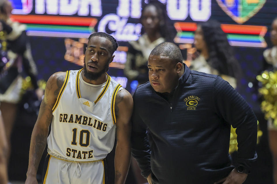 Grambling State guard Shawndarius Cowart (10) and head coach Donte' Jackson speak while Southern takes free throws in the first half of the NBA All-Star HBCU classic college basketball game Saturday, Feb. 18, 2023, in Salt Lake City. (AP Photo/Rob Gray)