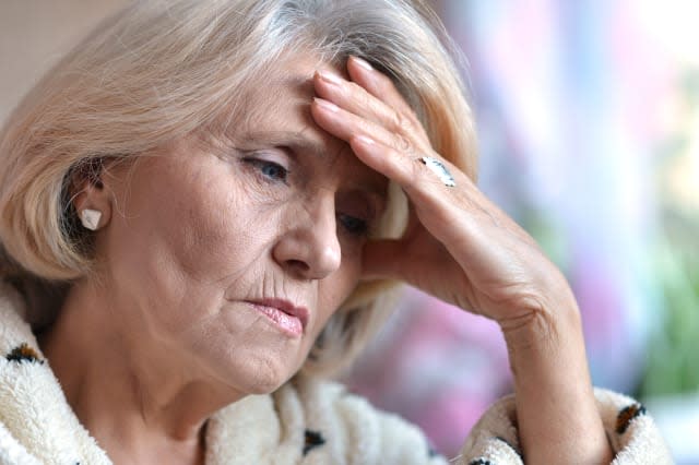 sad elderly woman sitting in a room