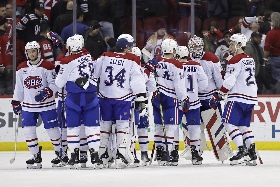 Montreal Canadiens goaltender Sam Montembeault, second form right, is congratulated after the Canadiens defeated the New Jersey Devils in an NHL hockey game Wednesday, Jan. 17, 2024, in Newark, N.J. (AP Photo/Adam Hunger)