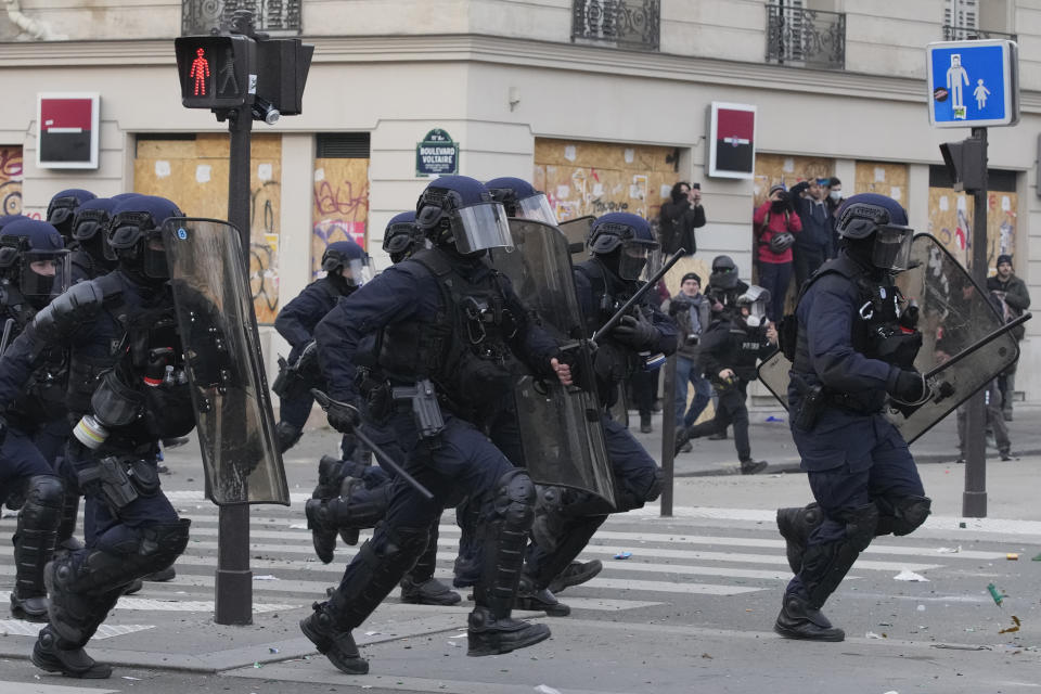 Members of the BRAV riot police officers unit charge after a demonstration Tuesday, March 28, 2023 in Paris. It's the latest round of nationwide demonstrations and strikes against unpopular pension reforms and President Emmanuel Macron's push to raise France's legal retirement age from 62 to 64. (AP Photo/Christophe Ena)