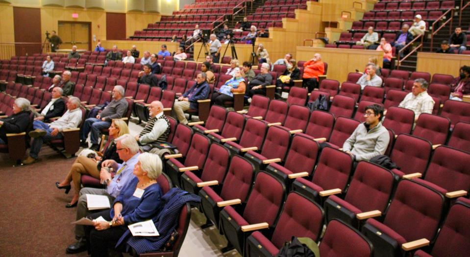 A small crowd gathers to listen to representatives from the MBTA speak about the South Coast Rail project at Morton Middle School on Thursday.