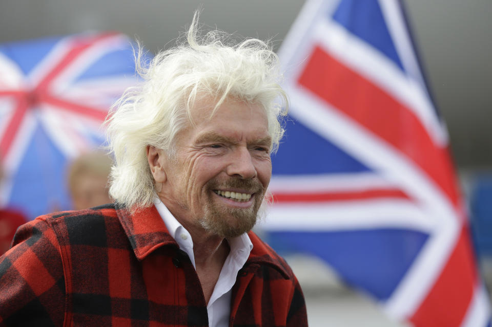 FILE - In this Monday, March 27, 2017 file photo, Richard Branson, founder of Virgin Atlantic and the Virgin Group, smiles at Seattle-Tacoma International Airport in Seattle. Branson has warned that a no-deal Brexit will force the company to invest less in Britain because of pressures on the pound. Branson has told the BBC on Thursday, July 11, 2019 that if the U.K. leaves the European Union without a deal, it will force his company to shift investment because its costs are in dollars. (AP Photo/Ted S. Warren, file)