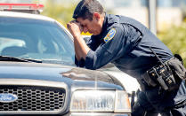 <p>A police officer reacts at the scene where a gunman shot and killed multiple people including himself at a UPS facility in San Francisco, California on June 14, 2017. (Josh Edelson/AFP/Getty Images) </p>