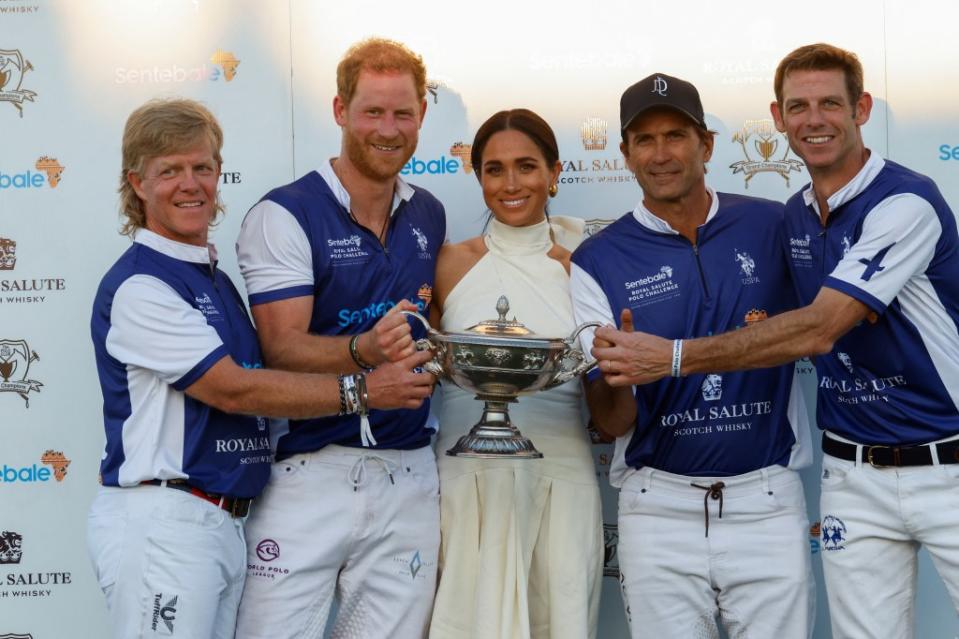 Britain’s Prince Harry and Meghan, Duchess of Sussex, pose with other players as they attend the Royal Salute Polo Challenge. REUTERS