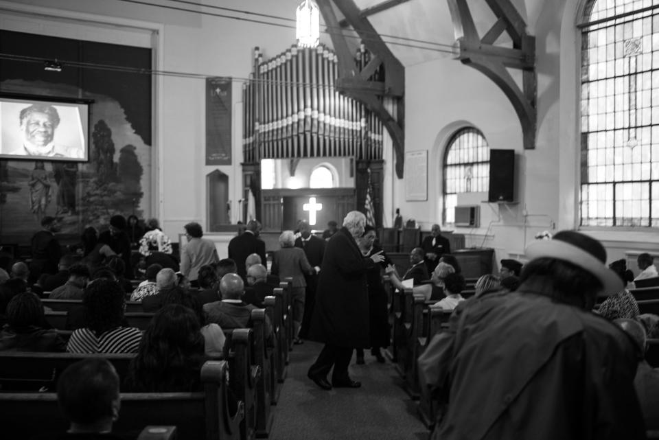 <p>Spencer Leak Sr greets relatives of the deceased at a funeral at the Union Tabernacle Missionary Baptist Church on Chicago’s south side. (Photo: Jon Lowenstein/NOOR for Yahoo News) </p>