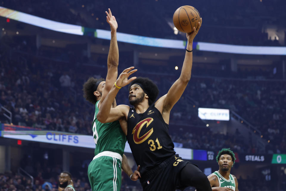 Cleveland Cavaliers center Jarrett Allen (31) shoots against Boston Celtics guard Derrick White (9) during the first half of an NBA basketball game, Wednesday, Nov. 2, 2022, in Cleveland. (AP Photo/Ron Schwane)