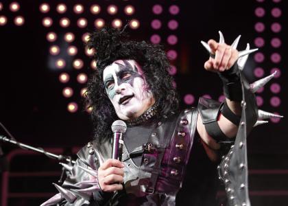 Tom Izzo talks to the crowd while dressed as a member of the band Kiss (AP)