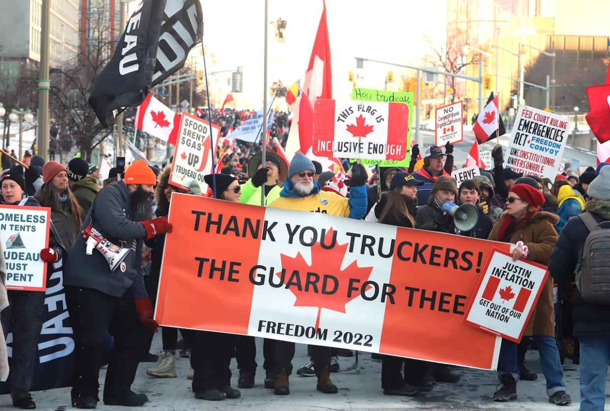 People gathered Saturday to mark the two-year anniversary of the police action that broke up what has become known as the Freedom Convoy demonstrations. Thousands of demonstrators took over streets around Parliament Hill in late January 2022, blocking roads with big-rig trucks and other vehicles and refusing to move.  (Patrick Doyle/The Canadian Press - image credit)