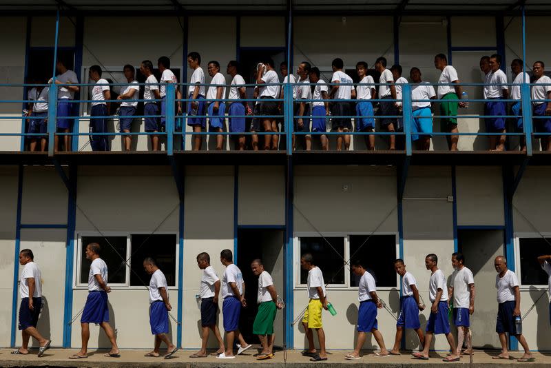 Drug rehab patients walk in formation to have lunch at the Mega Drug Abuse Treatment and Rehabilitation Center, in Nueva Ecija province