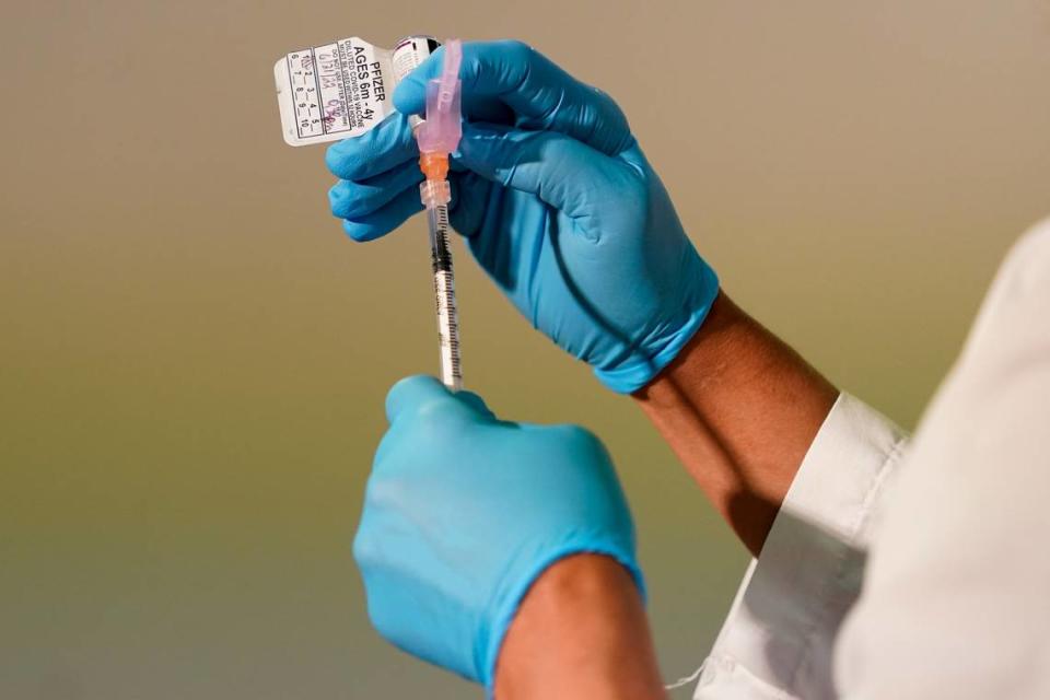 A registered nurse prepares a dose of the Pfizer COVID-19 vaccine in 2022.