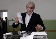 Lyutvi Mestan, leader of the DOST party, casts his ballot in Sofia, Bulgaria on Sunday, March 26, 2017. Bulgarians are heading to the polls for the third time in four years in a snap vote that could tilt the European Union's poorest member country closer to Russia as surveys put the GERB party neck-and-neck with the Socialist Party. (AP Photo/Valentina Petrova)