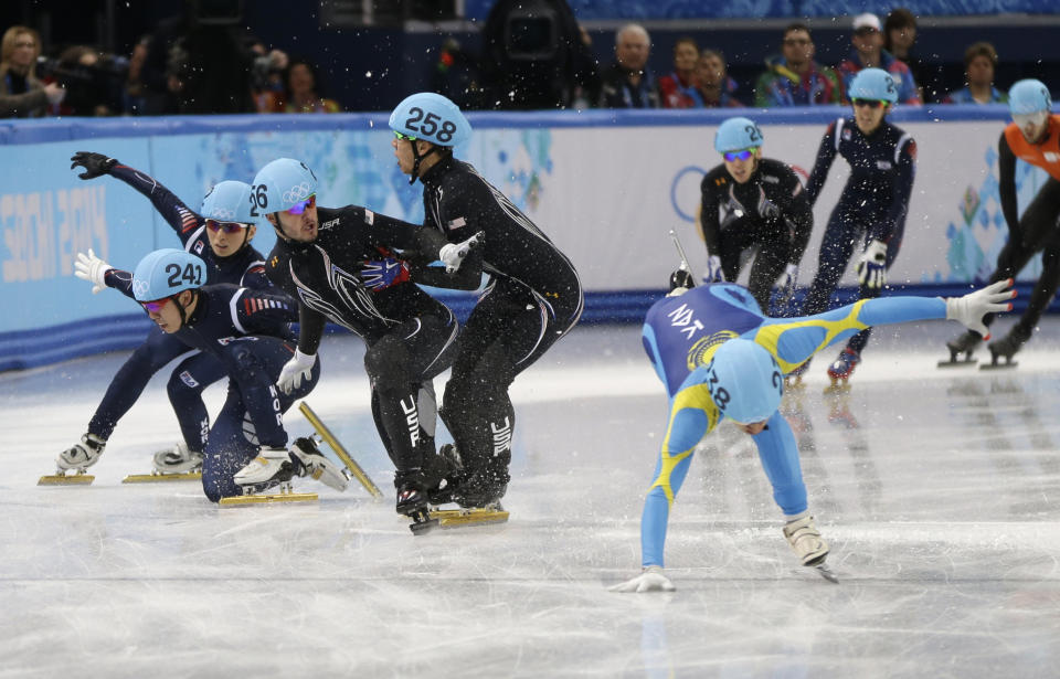 From left, Lee Ho-suk of South Korea, Park Se Yeong of South Korea, Eduardo Alvarez of the United States, and J.R. Celski of the United States struggle to keep their balance as they compete in a men's 5000m short track speedskating relay semifinal at the Iceberg Skating Palace during the 2014 Winter Olympics, Thursday, Feb. 13, 2014, in Sochi, Russia. (AP Photo/David Goldman)