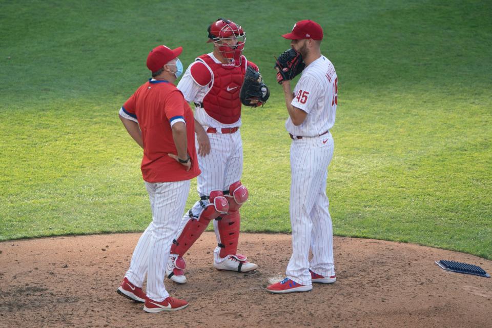 Price, then the Phillies' pitching coach, speaks to Zack Wheeler during a mound visit in 2020.