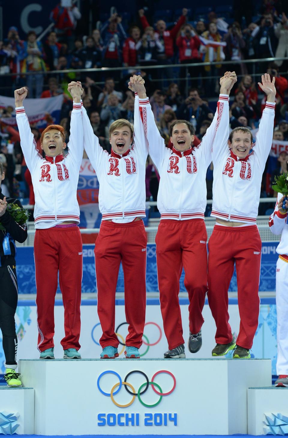 Russia's gold medalists Ruslan Zakharov, Vladimir Grigorev, Semen Elistratov and Victor An pose on the podium during the Men's Short Track 5000 m Relay Flower Ceremony at the Iceberg Skating Palace during the Sochi Winter Olympics on February 21, 2014.  AFP PHOTO / JUNG YEON-JE        (Photo credit should read JUNG YEON-JE/AFP/Getty Images)