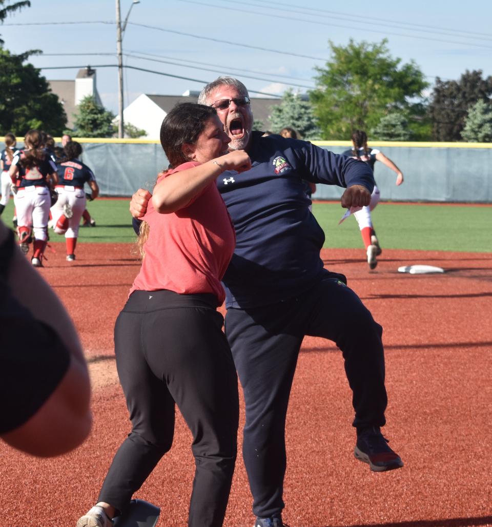 The New Hartford coaching staff celebrates after winning the Section III Class A championship over Auburn at Onondaga Community College Thursday, June 2, 2022.