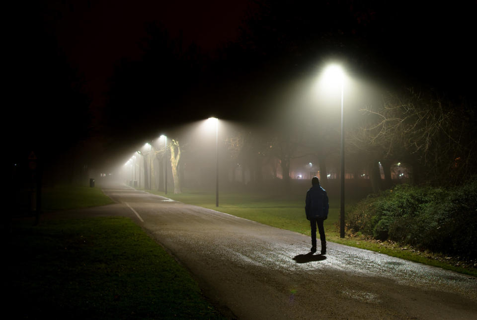 Single person walking on street in the dark night