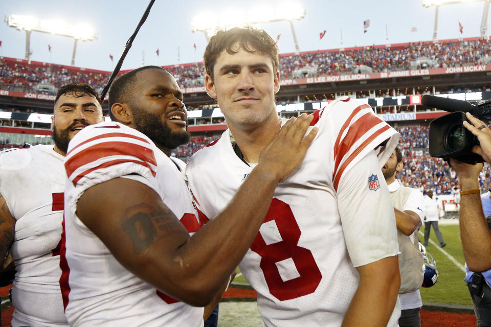 Sep 22, 2019; Tampa, FL, USA; New York Giants quarterback Daniel Jones (8) and running back Elijhaa Penny (39) hug after defeating the Tampa Bay Buccaneers at Raymond James Stadium. Mandatory Credit: Kim Klement-USA TODAY Sports