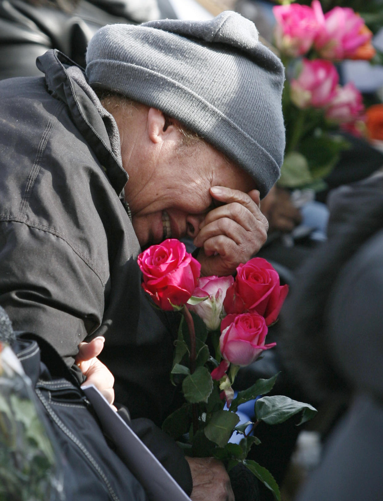 Image: A woman greaves as she listens to the names of loved ones being called out during the seventh anniversary memorial service for Flight 587 in Belle Harbor, N.Y.,  Nov. 12, 2008. (Stuart Ramson / AP file)