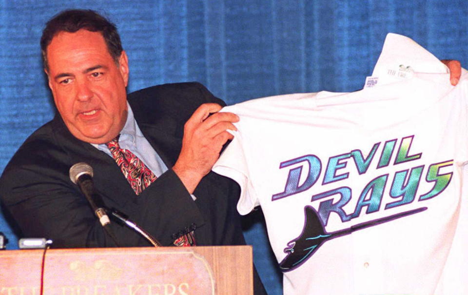 PALM BEACH, FL - MARCH 9:  Vince Naimoli, owner of the "Tampa Bay Devil Rays" displays his new team's jersey to reporters 09 March in Palm Beach, Florida.  Members of the Major League Expansion Committee announced Naimoli's team would be one of two new expansion teams approved for baseball. The new team will begin playing in the 1998 season. (COLOR KEY: Background is blue.) AFP PHOTO  (Photo credit should read DOUG COLLIER/AFP/Getty Images)