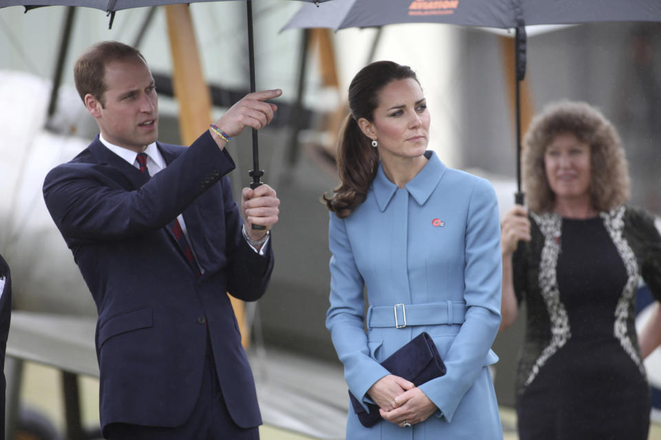 Britain's Prince William, left, and his wife Kate, the Duchess of Cambridge, center, tour the Omaka Aviation Heritage Centre in Blenheim, New Zealand, Thursday, April 10, 2014. (AP Photo/Tim Cuff, Pool)