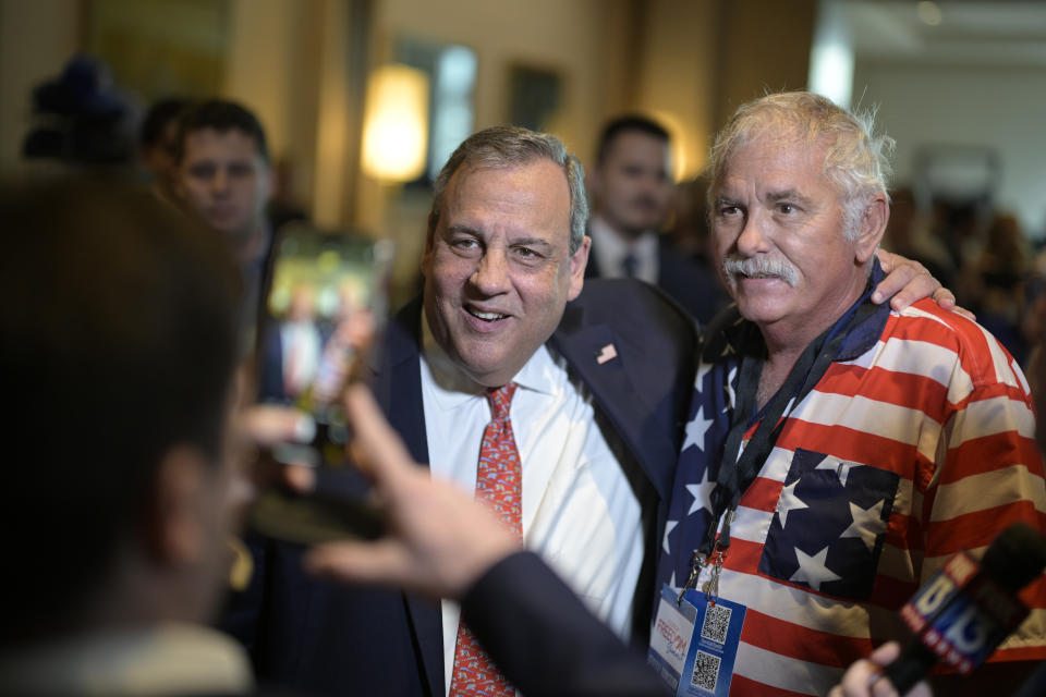 Republican presidential candidate former New Jersey Gov. Chris Christie, center, poses for a photo with an attendee after speaking at the Republican Party of Florida Freedom Summit, Saturday, Nov. 4, 2023, in Kissimmee, Fla. (AP Photo/Phelan M. Ebenhack)