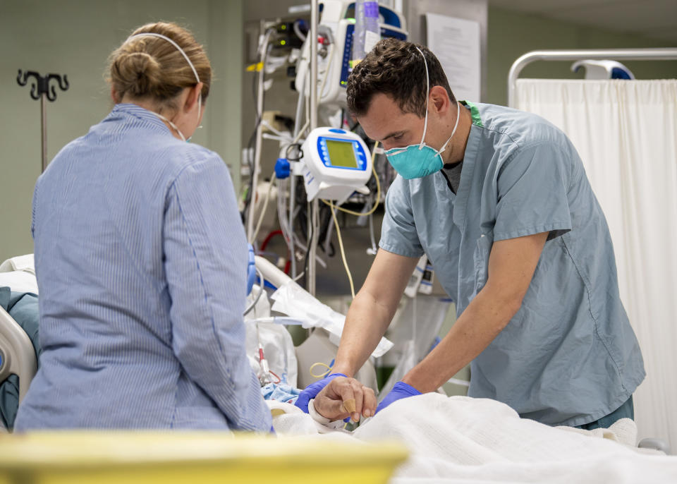 Lt. Wade Miller, from Orlando, Florida, treats a non-COVID-19 patient aboard the hospital ship USNS Mercy on Saturday. (Photo: U.S. Navy/Ryan M. Breeden)