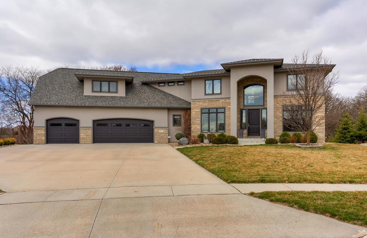 This $1,975,000 Urbandale home includes heated floors, a steam shower and four fireplaces, Here, a look at the front of the home.