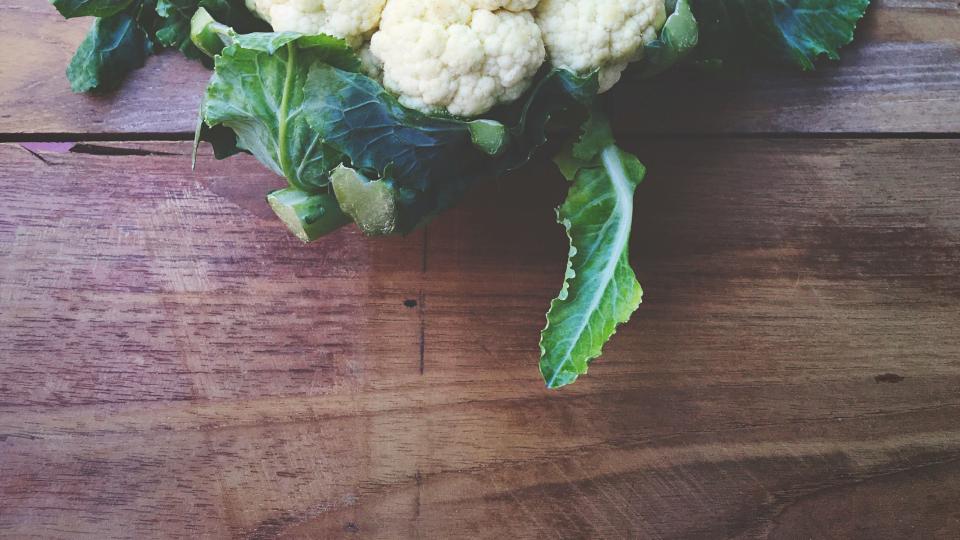 High Angle View Of Cauliflowers On Wooden Table