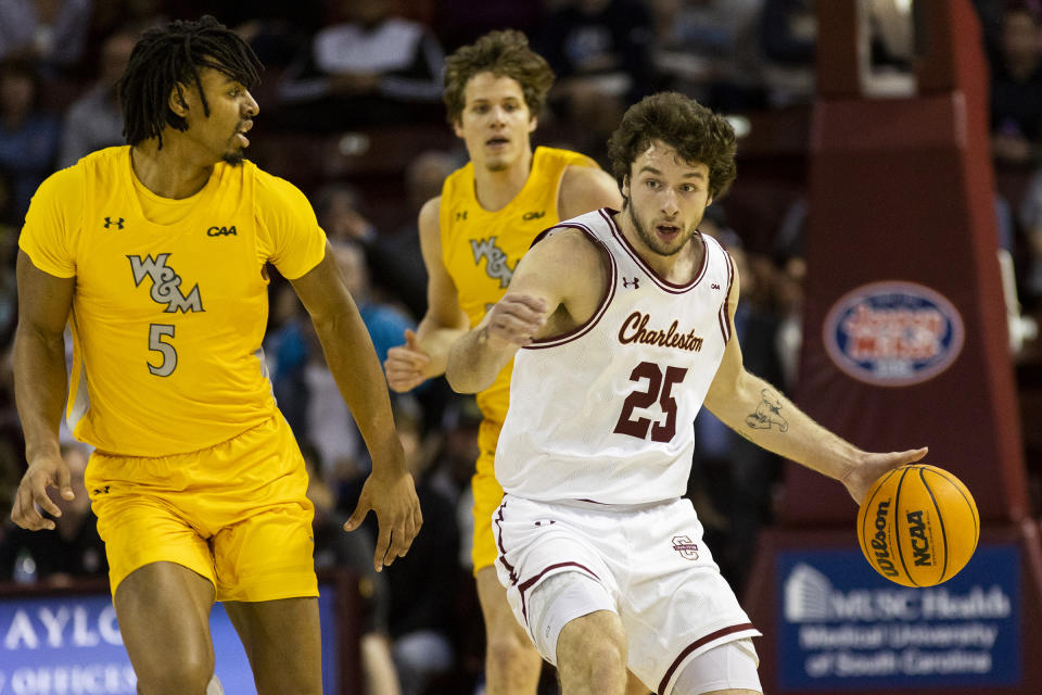 College of Charleston's Ben Burnham (25) dribbles the ball against the defense of William & Mary's Noah Collier (5) in the first half of an NCAA college basketball game in Charleston, S.C., Monday, Jan. 16, 2023. (AP Photo/Mic Smith)
