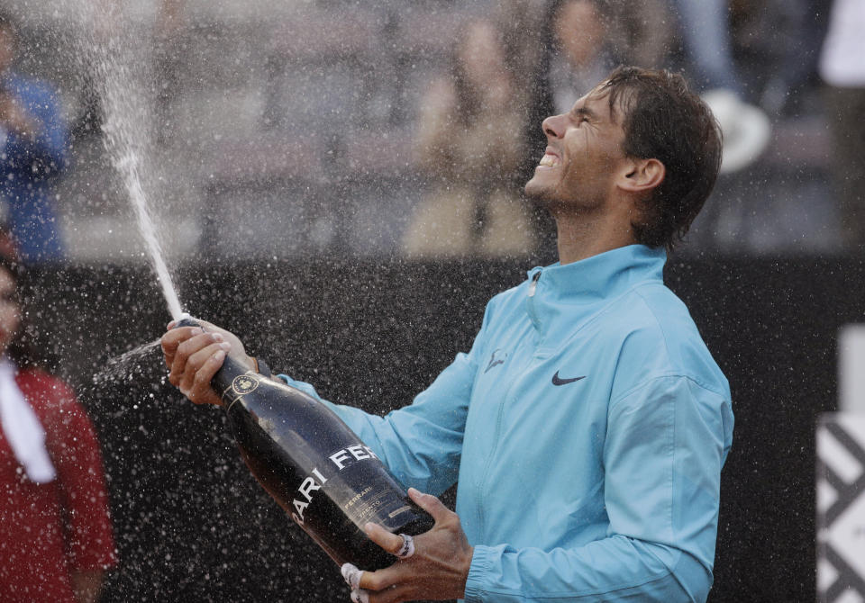 Rafael Nadal of Spain celebrates with sparkling wine after winning against Novak Djokovic of Serbia at the end of their final match at the Italian Open tennis tournament, in Rome, Sunday, May 19, 2019. (AP Photo/Gregorio Borgia)