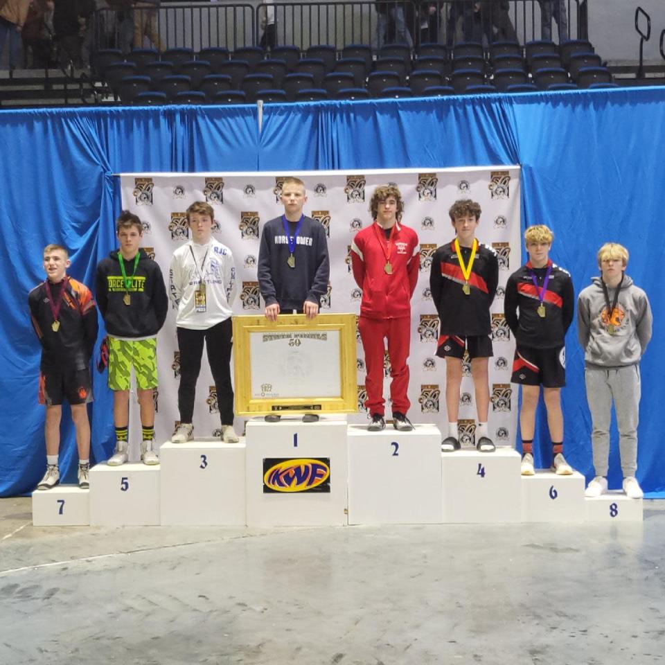 Jimmy Mastny of the Alber Athletics Wrestling Club stands atop the podium after winning the IKWF state title in the Senior Division at 126 pounds at the BMO Harris Bank Center in Rockford on Saturday, March 12, 2022.