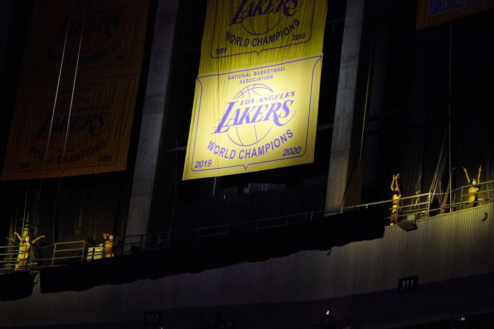 Members of the Laker Girls dance after the Los Angeles Lakers unveiled their 2019-2020 World Championship banner prior to an NBA basketball game against the Houston Rockets Wednesday, May 12, 2021, in Los Angeles. (AP Photo/Mark J. Terrill)