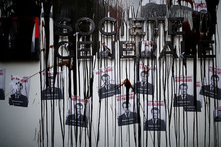 The Societe Generale logo is covered by molasses representing oil as Environmental activists block the entrance of the French bank Societe Generale headquarters during a "civil disobedience action" to urge world leaders to act against climate change, in La Defense near Paris, France, April 19, 2019. REUTERS/Benoit Tessier