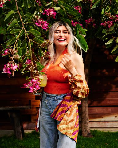 <p>Eva Kolenko / Food Styling by Carrie Purcell / Prop Styling by Nidia Cueva</p> Restaurateur Bricia Lopez enjoys a glass of Sparkling Mezcal Water at her backyard asada.