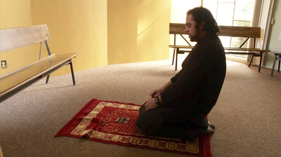 In this image taken from video, Adeel Zeb, Islamic chaplain at the five-college Claremont Colleges network in California, prays during a break in his day, Thursday, Jan. 30, 2020. Zeb, who meditates and works out to deal with the stresses of being a faith leader, says, “I have to make sure there’s a very strong dose of self-care, so I can be resilient.” (AP Photo/Aron Ranen)