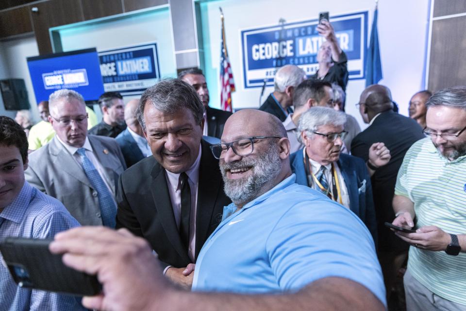 Westchester County Executive George Latimer takes a photo with his supporter at his election night party in White Plains, NY, Tuesday, June 25, 2024. (AP Photo/Jeenah Moon)